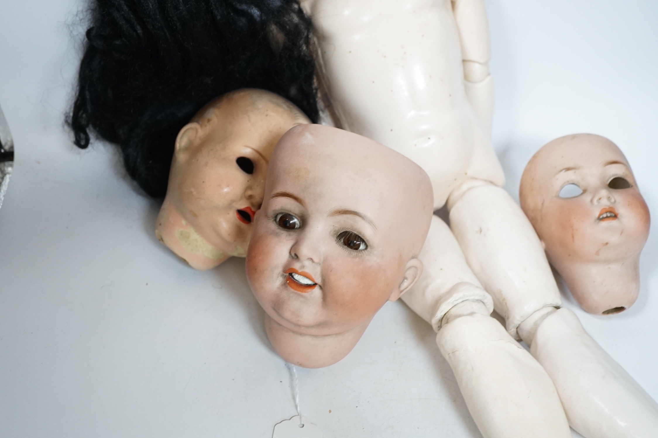 A Heubach doll and five bisque doll’s heads